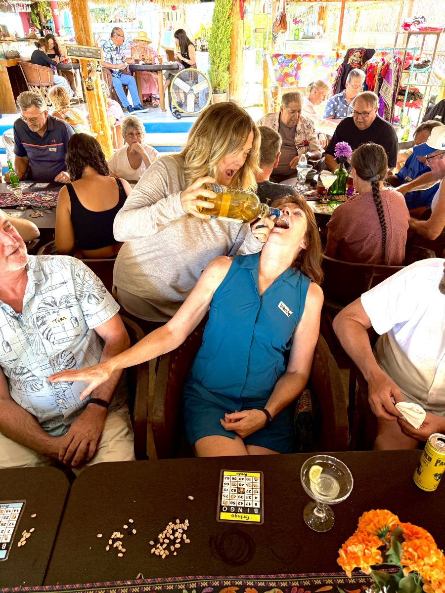<who>Photo credits: Steve MacNaull/NowMedia Group</who>Wendy Kyle from Saskatoon gets her Gringo Bingo 'drinko' shot from Laurie The Tequila Fairy